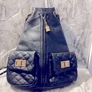 Black faux leather chain backpack.